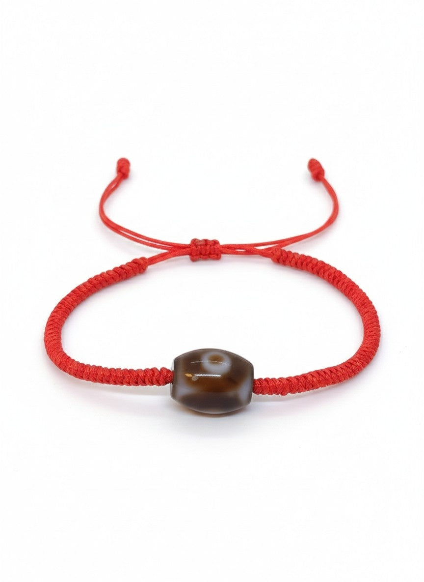 Bracelet porte-bonheur tibétain rouge perle dzi tressé à la main